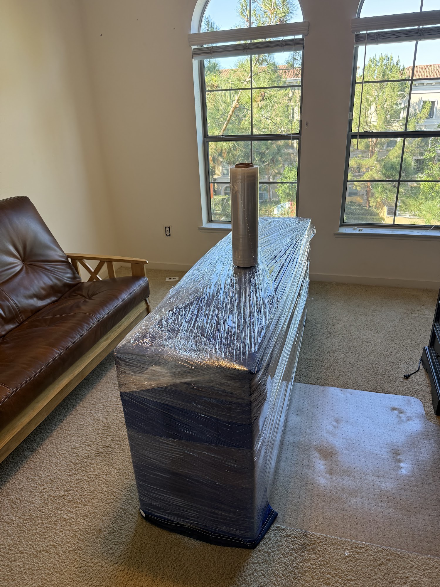 Moving team wrapping and loading furniture