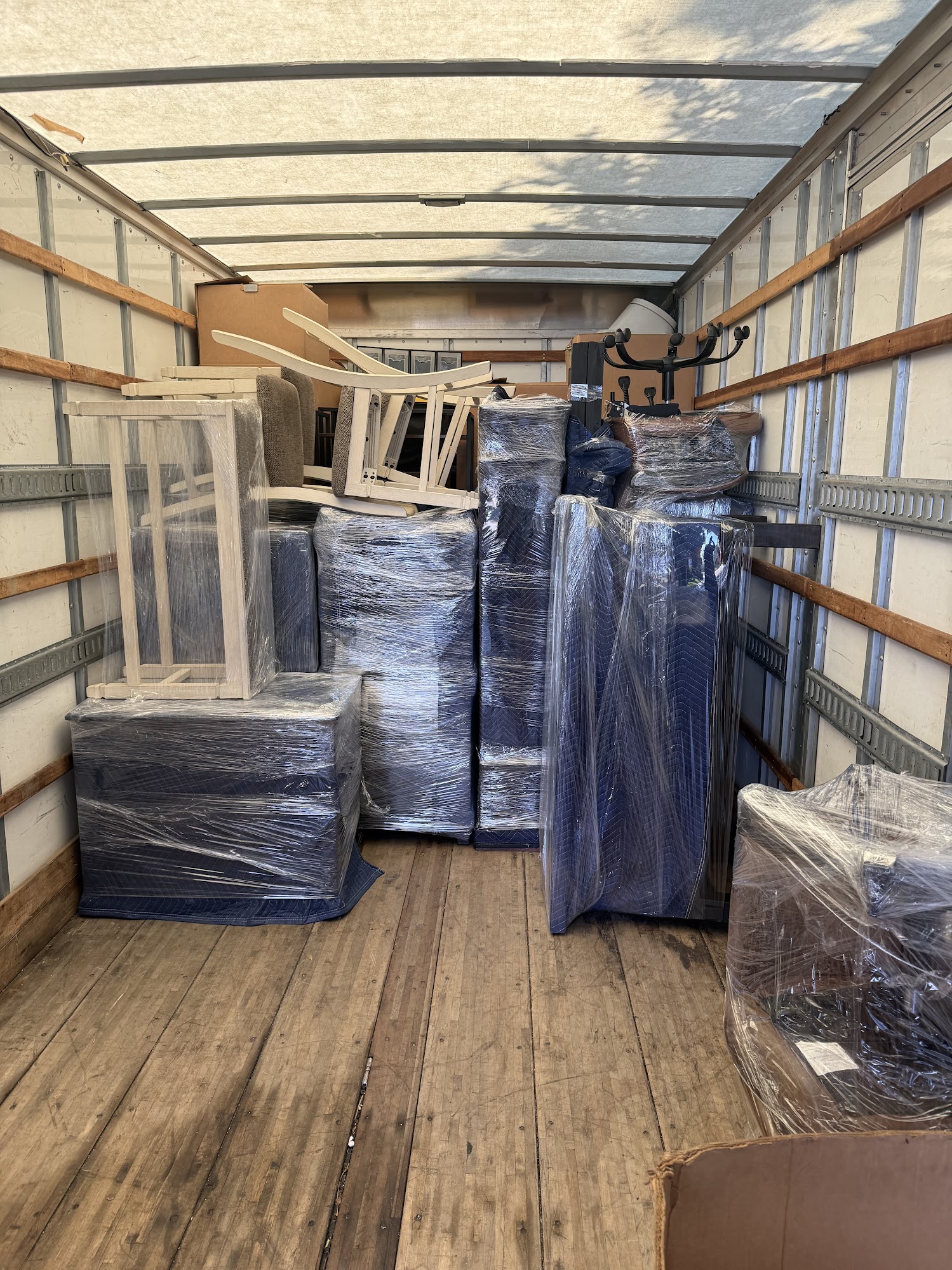 SMG Movers & Cleaning LLC 26ft commercial moving truck loading at residential home in Irvine