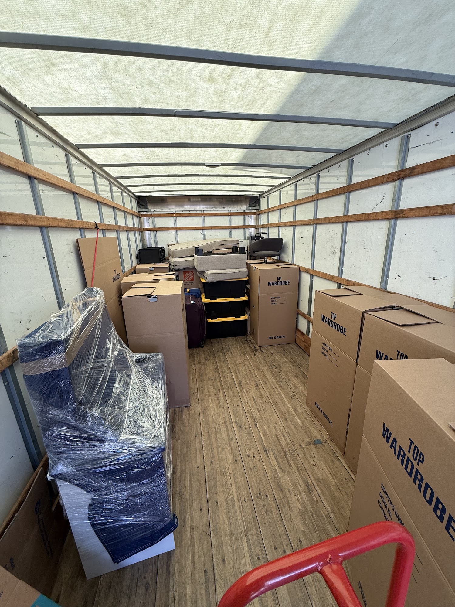 Office desks and commercial computer setups prepared for transport in Huntington Beach