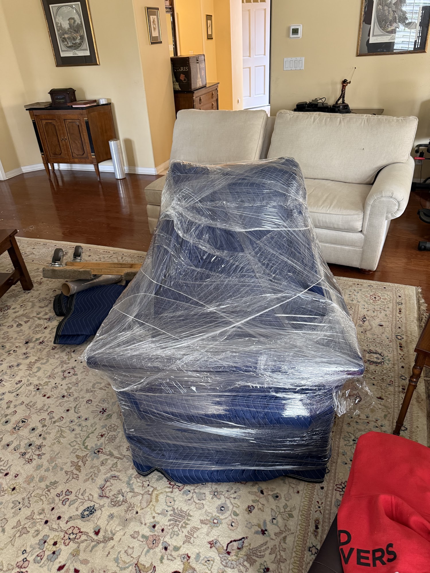 Carefully padding glass dining tabletop and chairs for local move in Anaheim