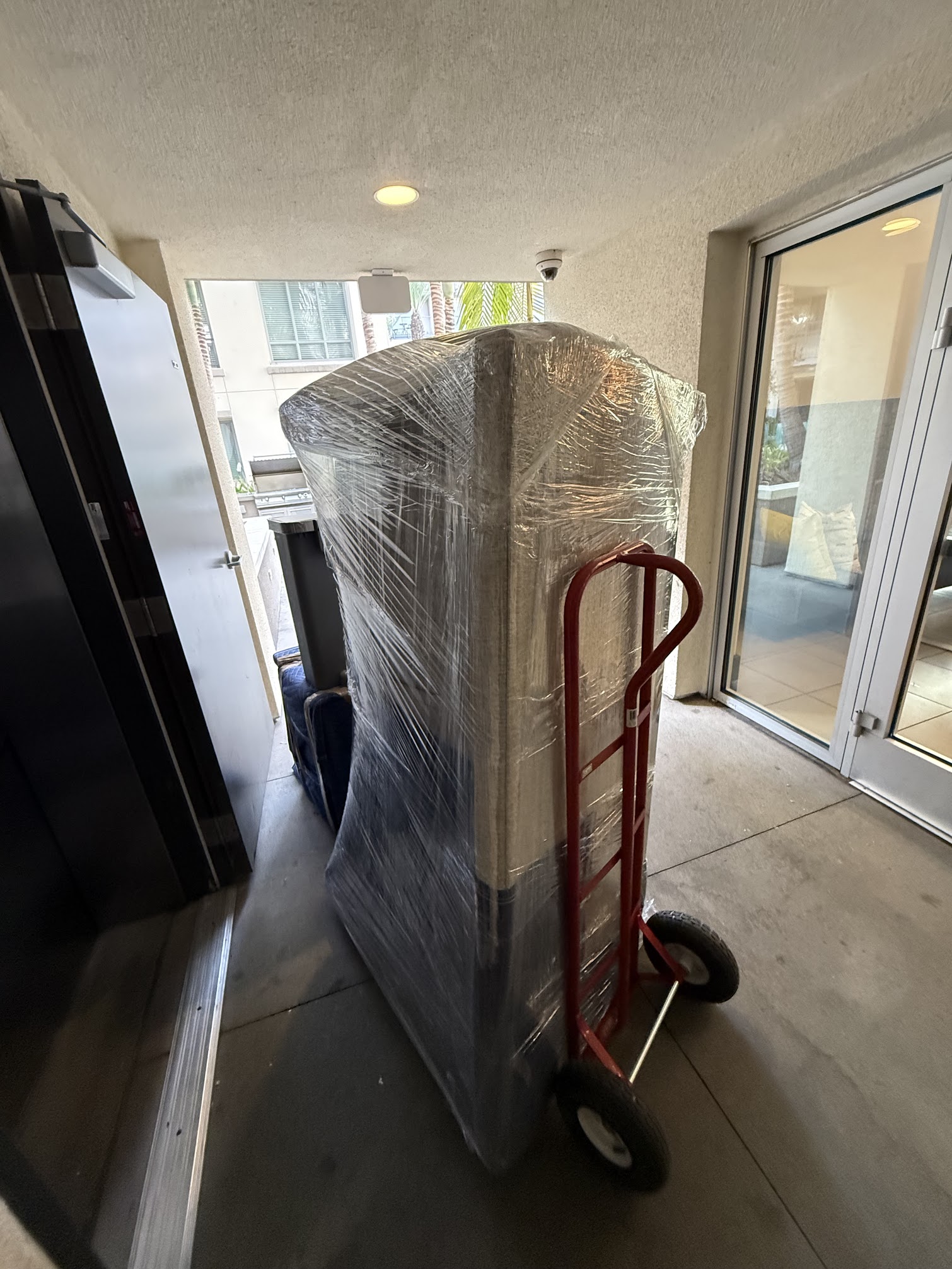 SMG Movers & Cleaning LLC crew carrying boxes during local move in Newport Beach