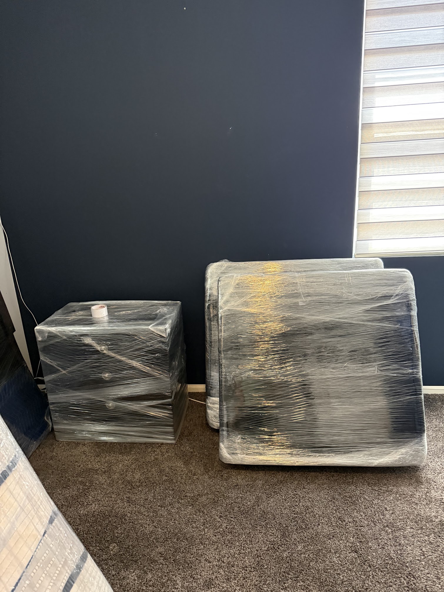 Moving team protecting furniture with blankets and wrap