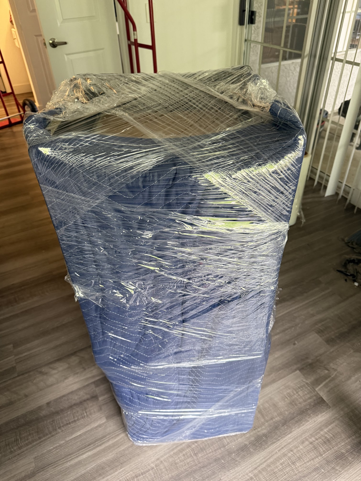Professional movers wrapping items for safe transport in Orange County
