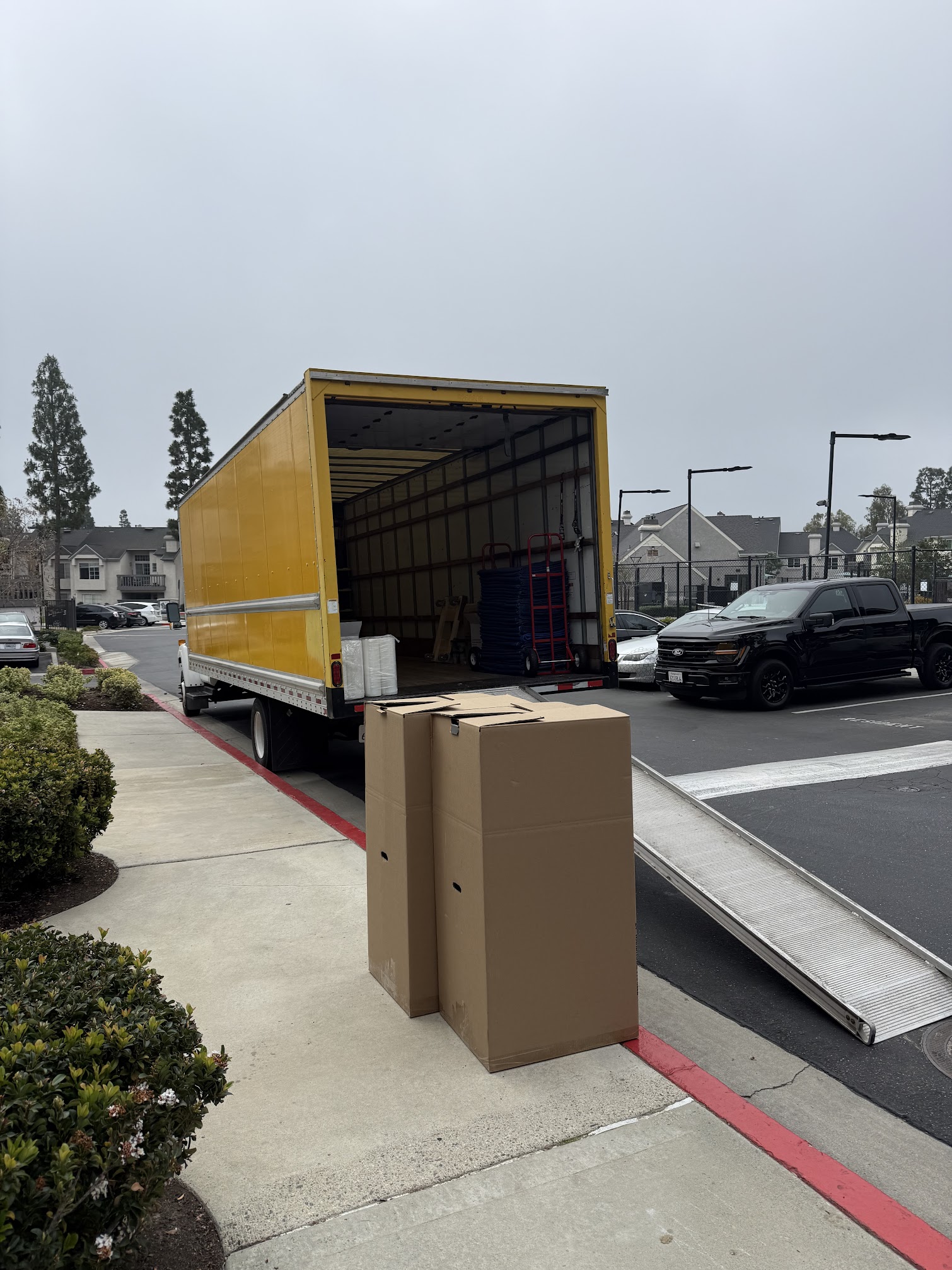 SMG Movers & Cleaning LLC crew carrying boxes during local move in Newport Beach