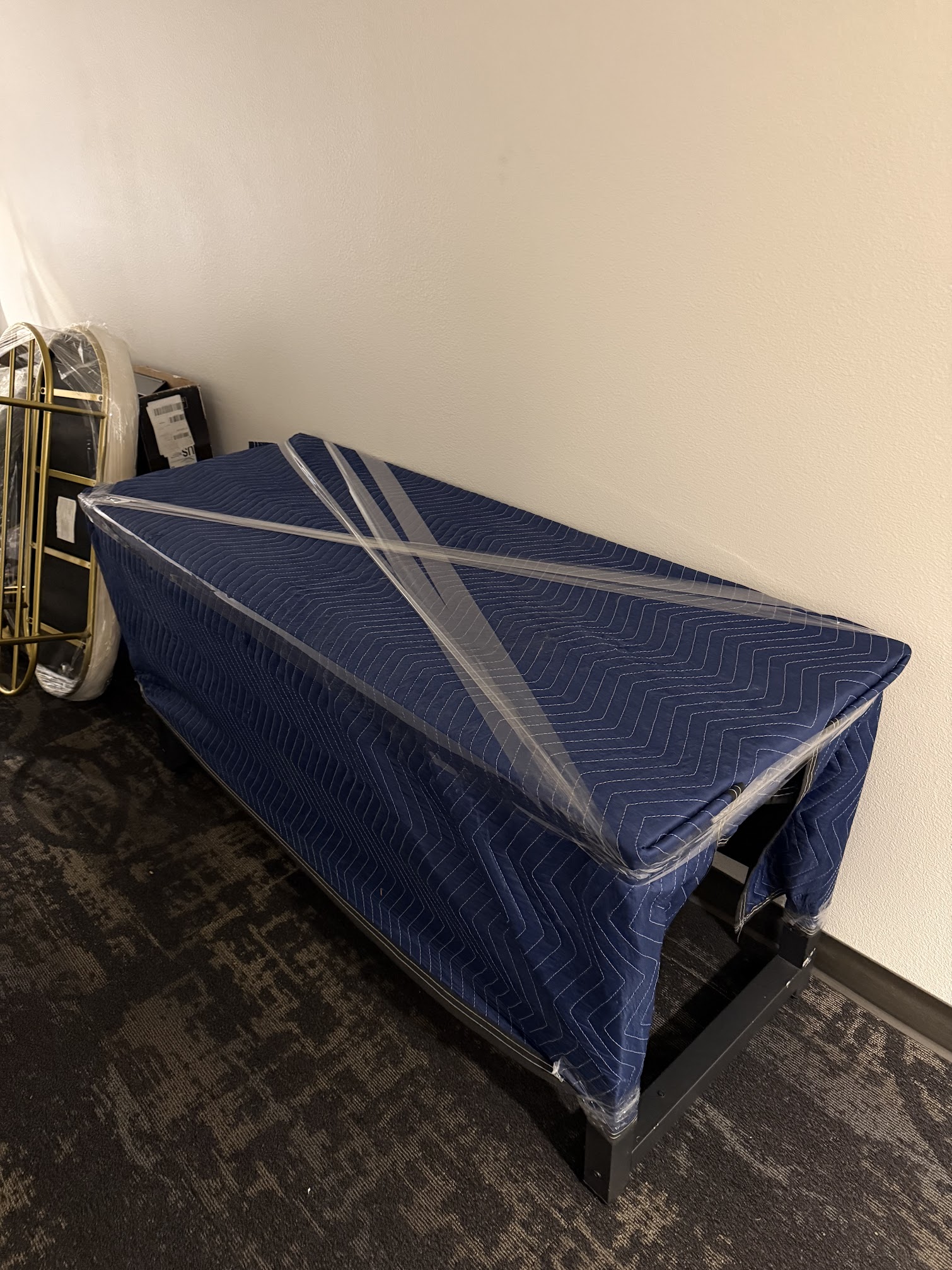 Moving team protecting furniture with blankets and wrap